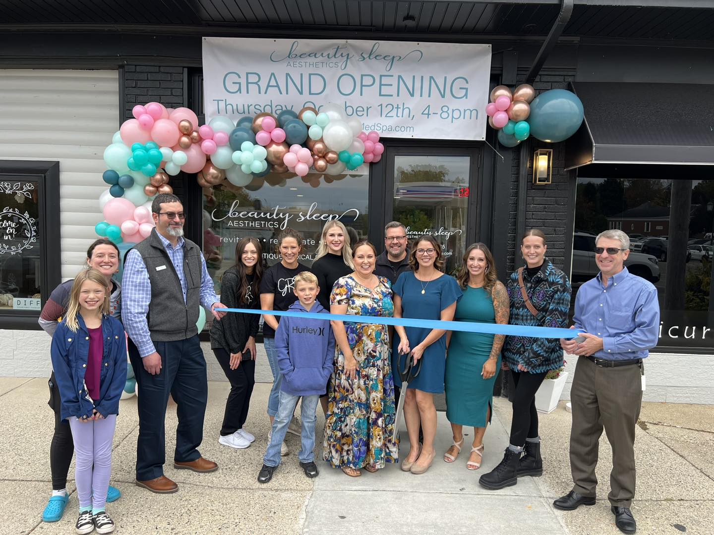 Beauty Sleep Aesthetics grand-opening ribbon-cutting in front of the downtown Rockford storefront